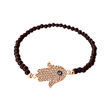  [[Black bead bracelet with a gold color hamsa symbol///Bracelet de perles noires avec un symbole hamsa de couleur or]]